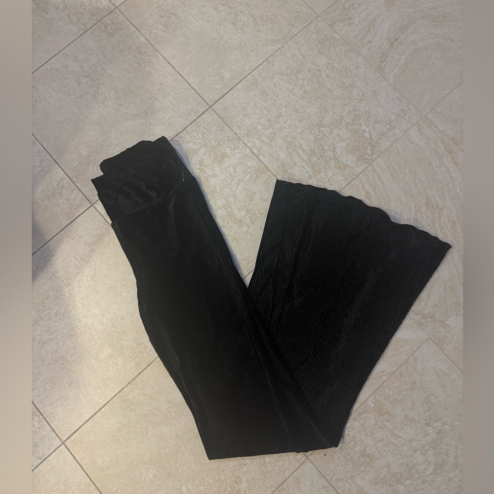 Out from under black velvet pants